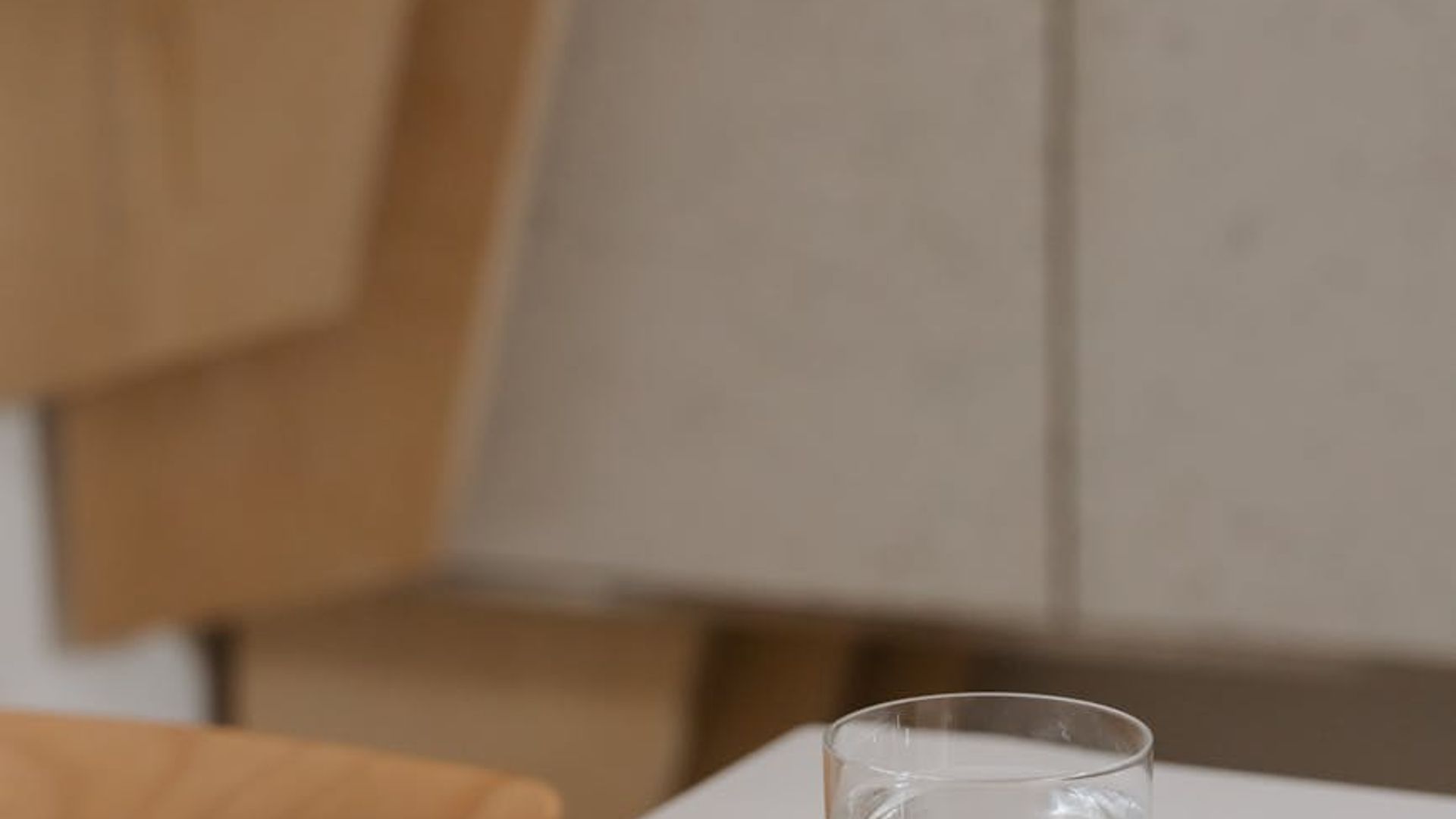 A calm, minimalist space with soft lighting, suggesting focus and movement.